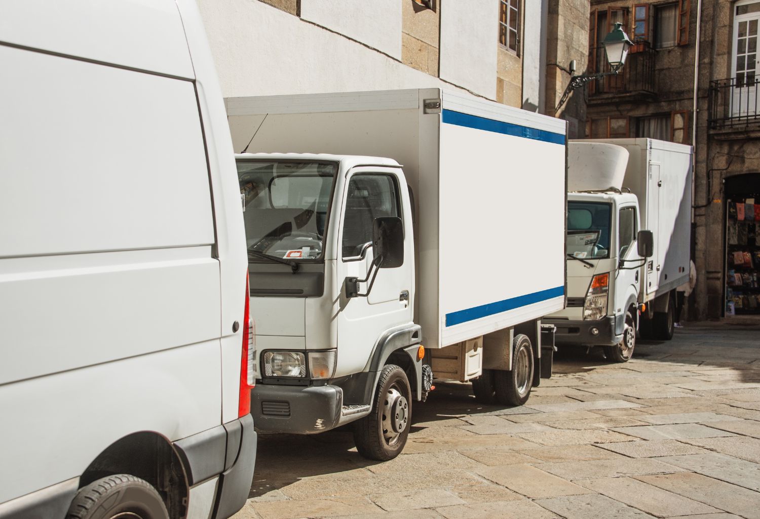 Last-Mile Delivery - Delivery trucks in a street of the city center of Pontevedra, Spain.